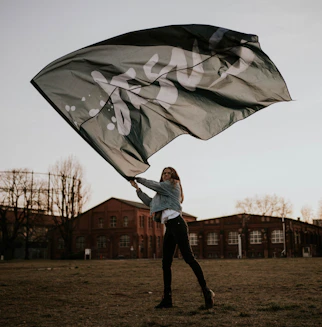 man in white jacket holding umbrella