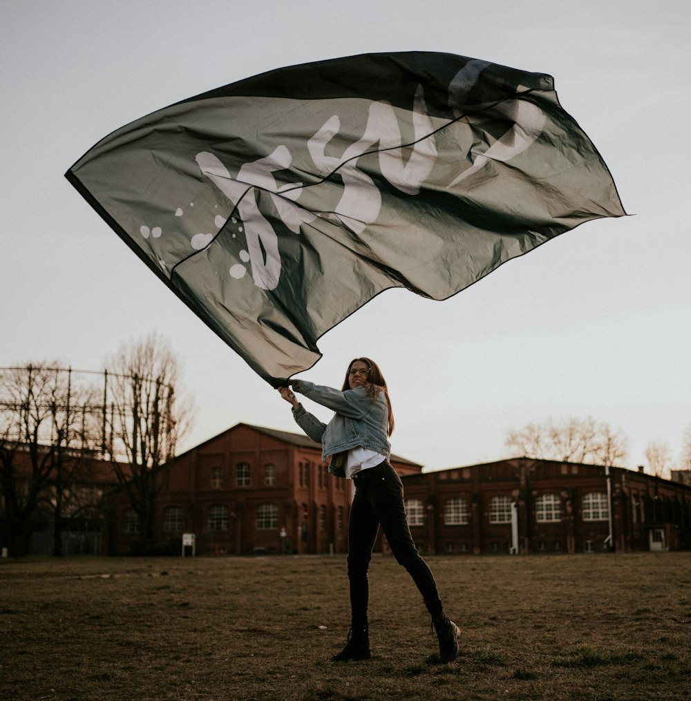 man in white jacket holding umbrella