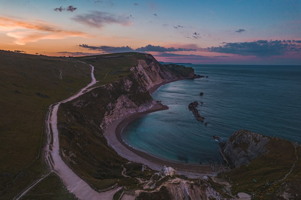 aerial view of sea and mountain during sunset