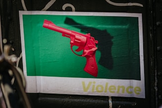 red pistol on green and white textile