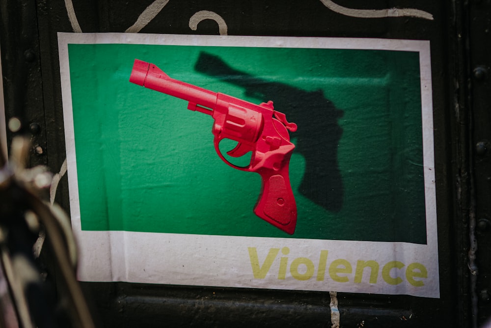 red pistol on green and white textile