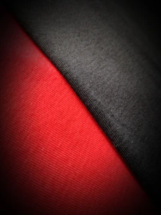Close-up of premium fabric textures in black and red, highlighting quality and durability.