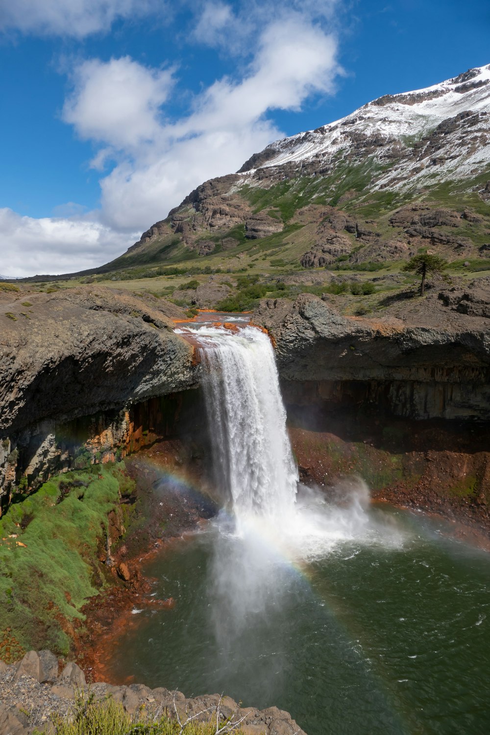 a waterfall with a rainbow in the middle of it