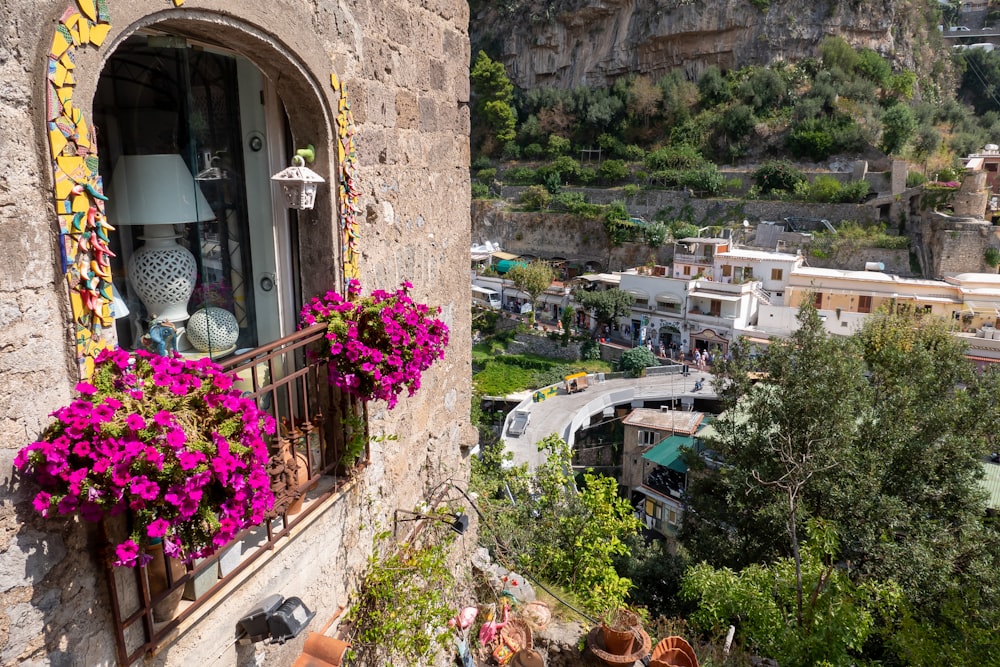 a balcony with flowers and potted plants on it