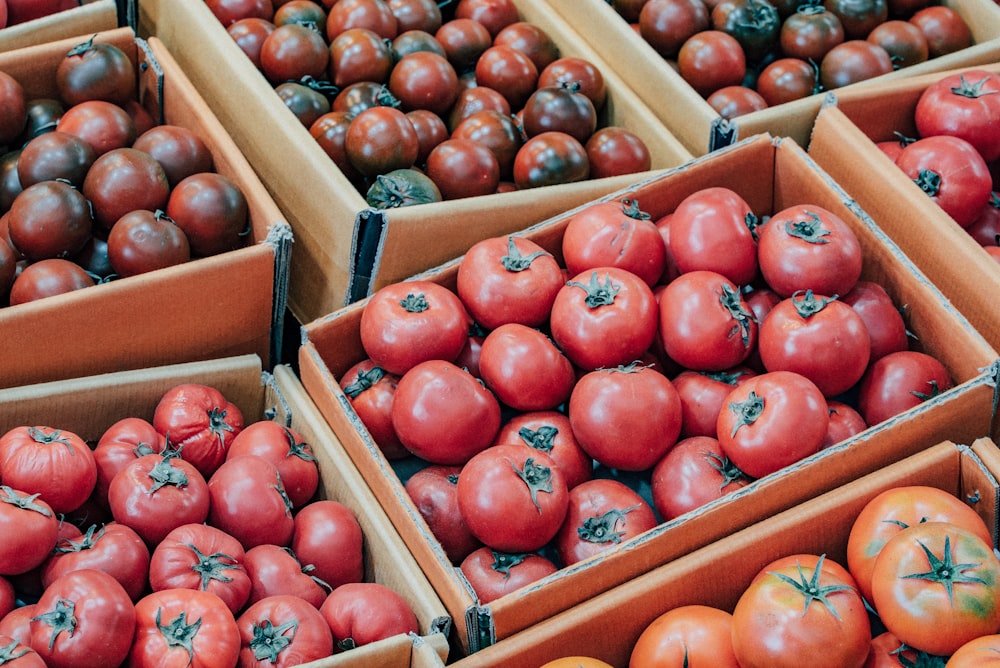 red tomatoes on brown wooden crate