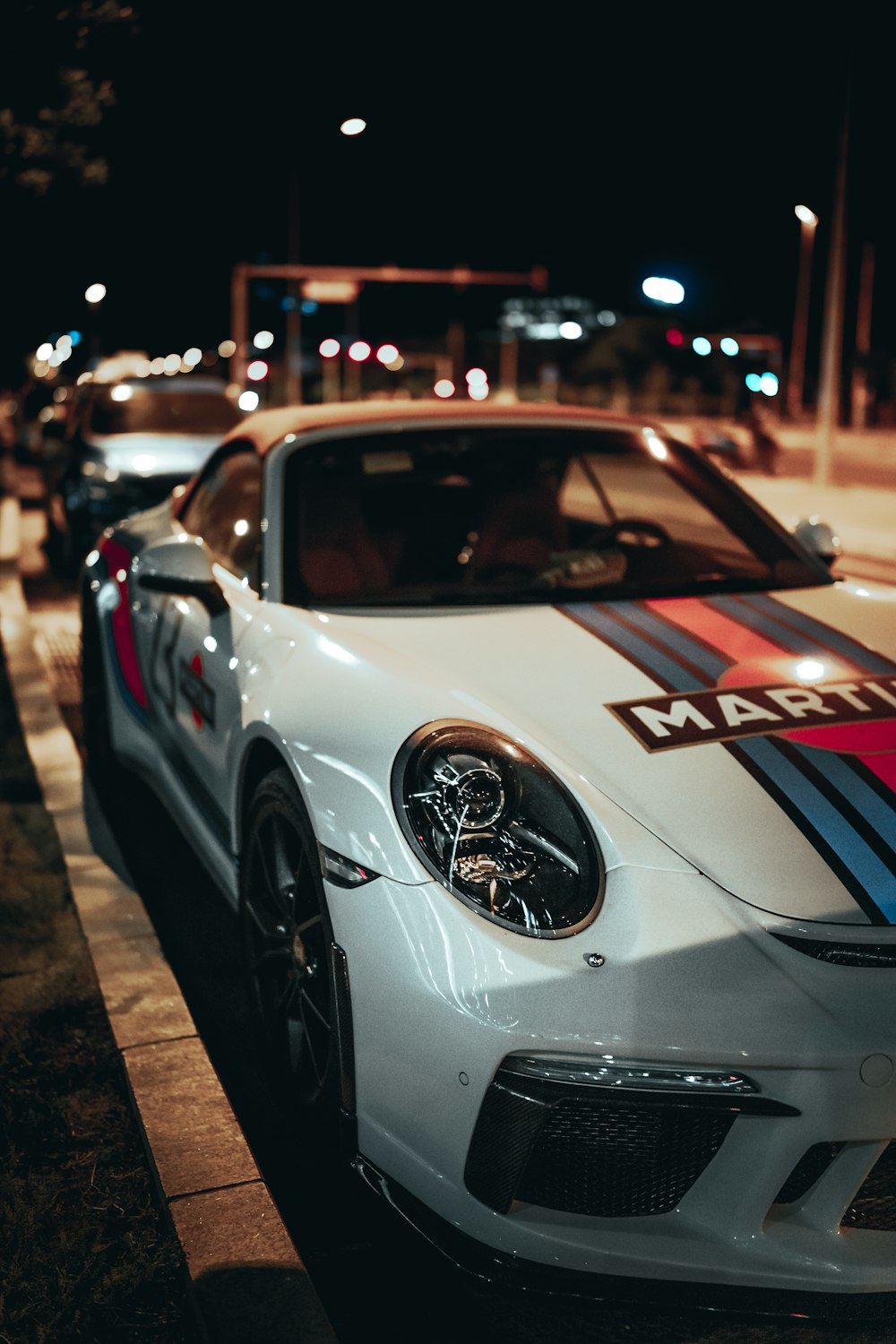 white porsche 911 parked on street during night time