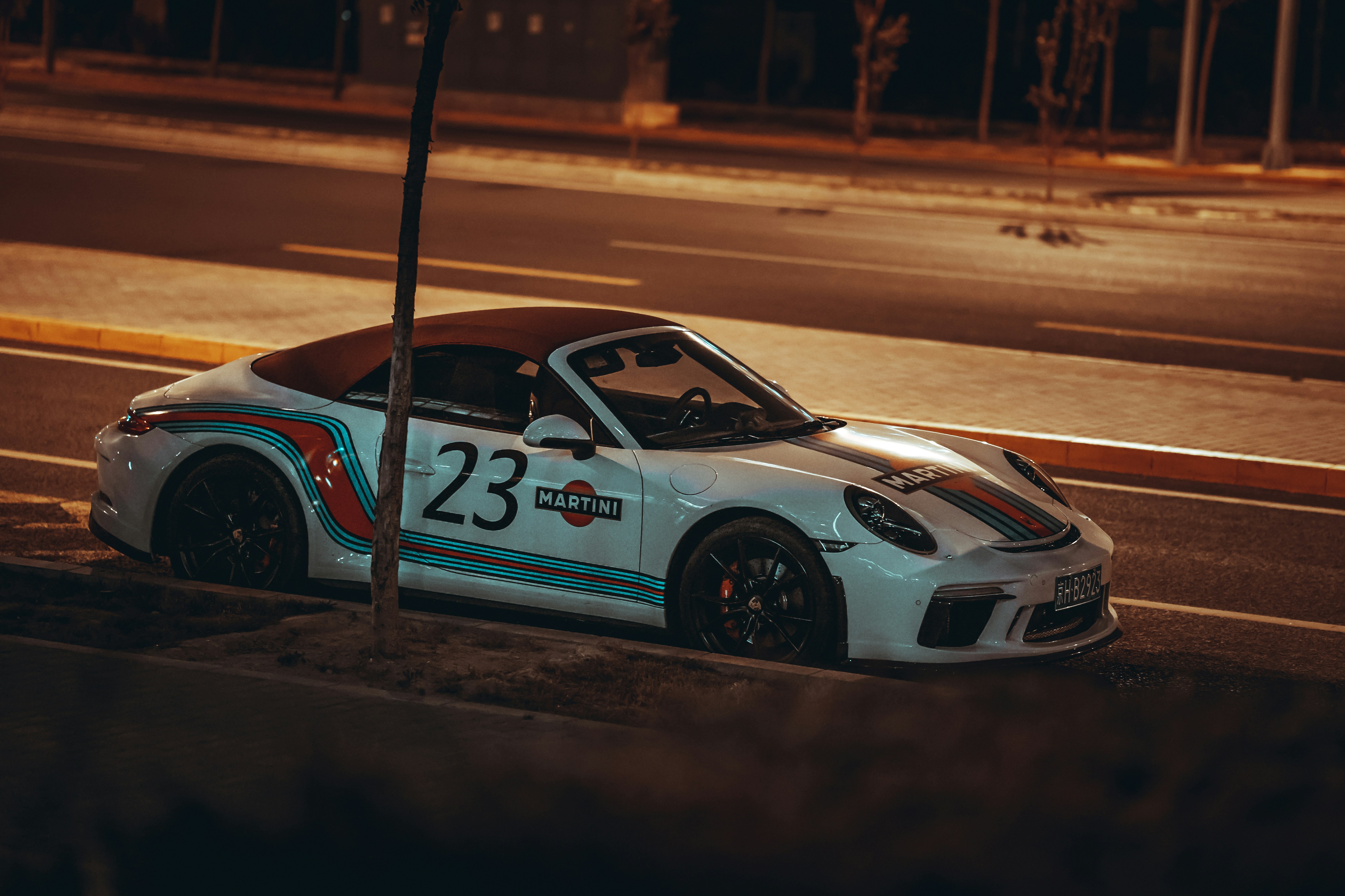 white and blue porsche 911 on road during daytime