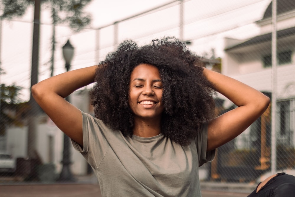 a woman with her hands on her head