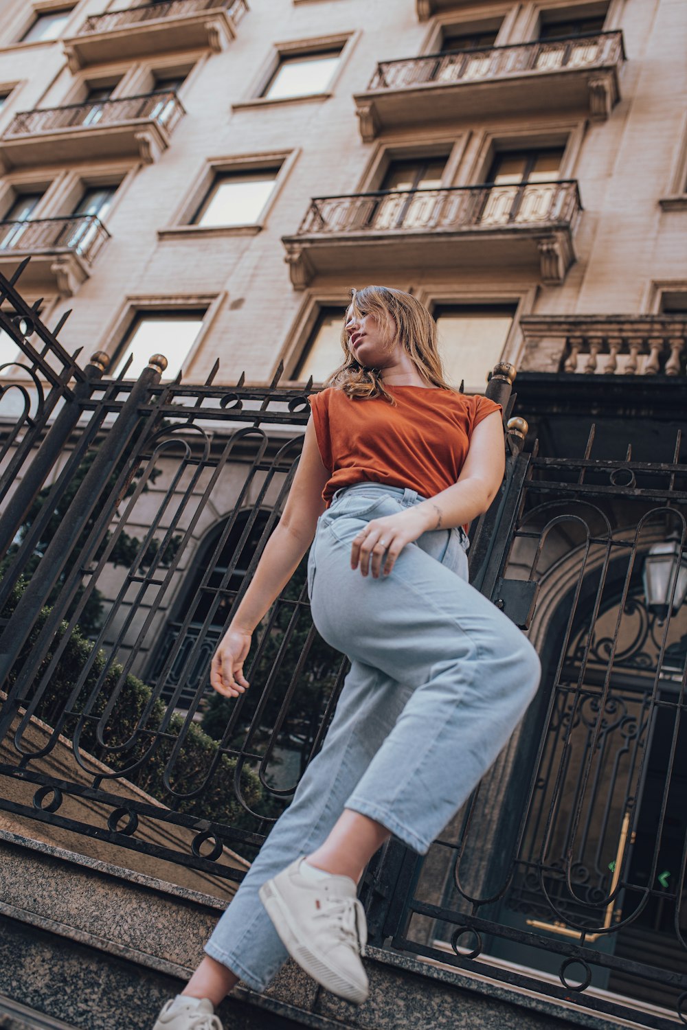 a woman standing on the steps of a building