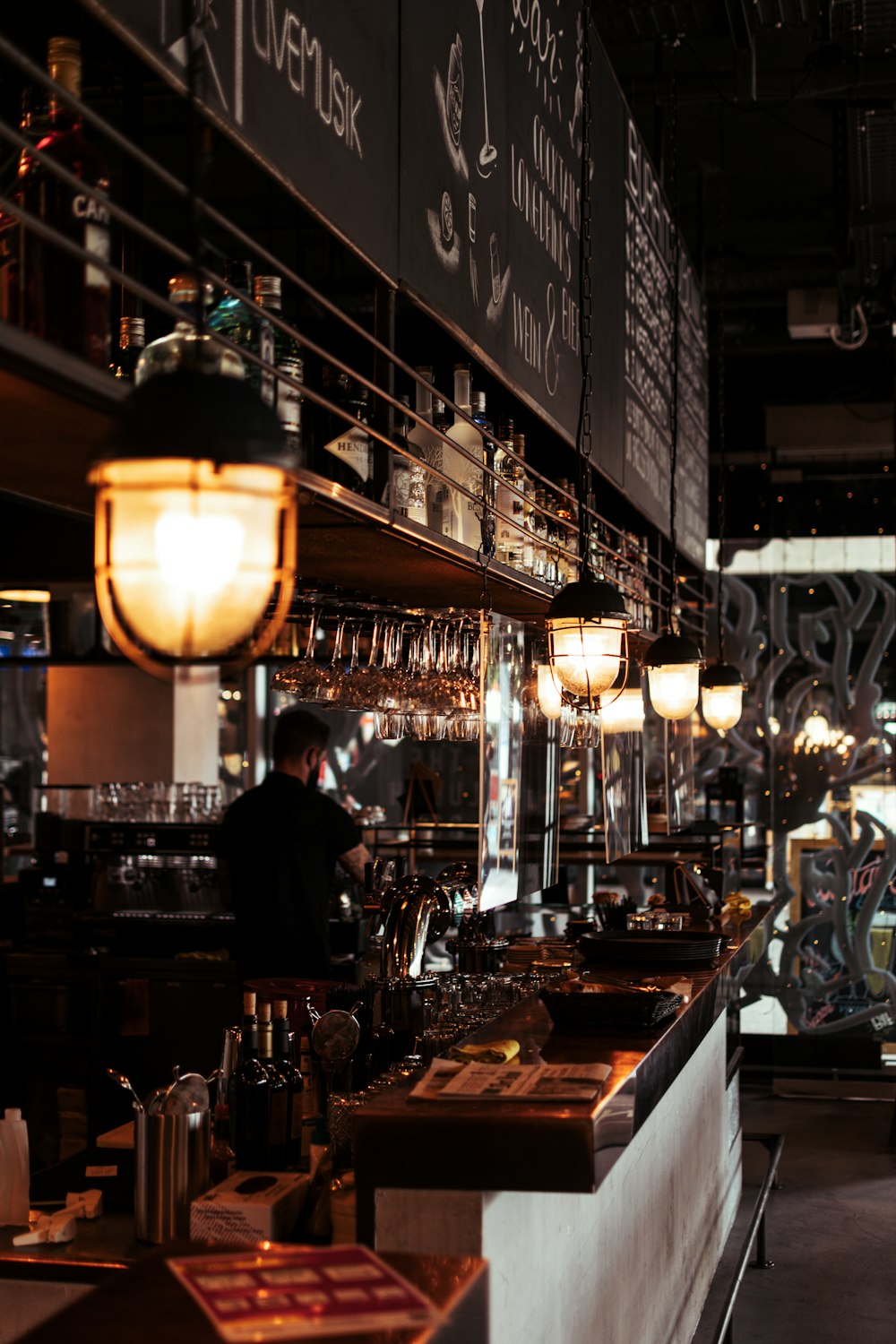 a bar with a lot of bottles and glasses on it