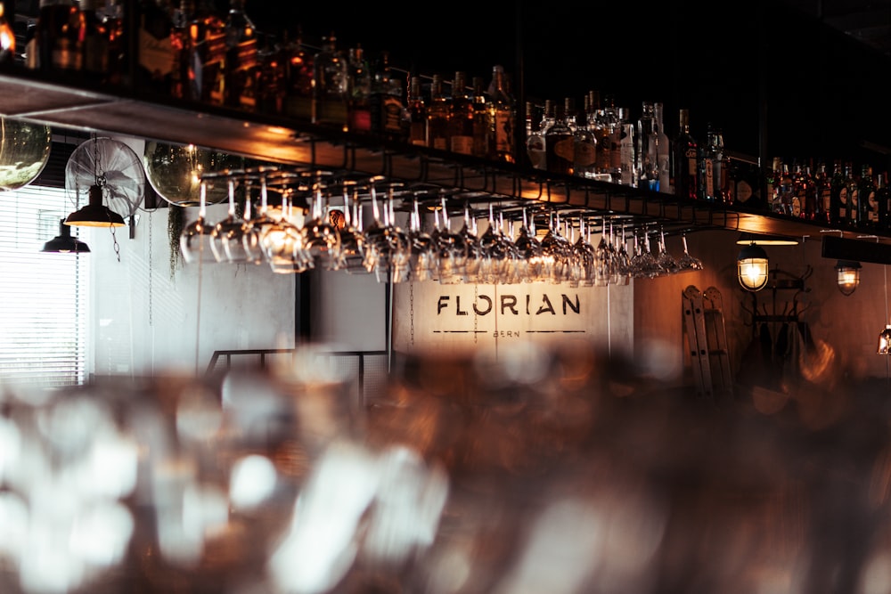 a row of wine glasses sitting on top of a bar