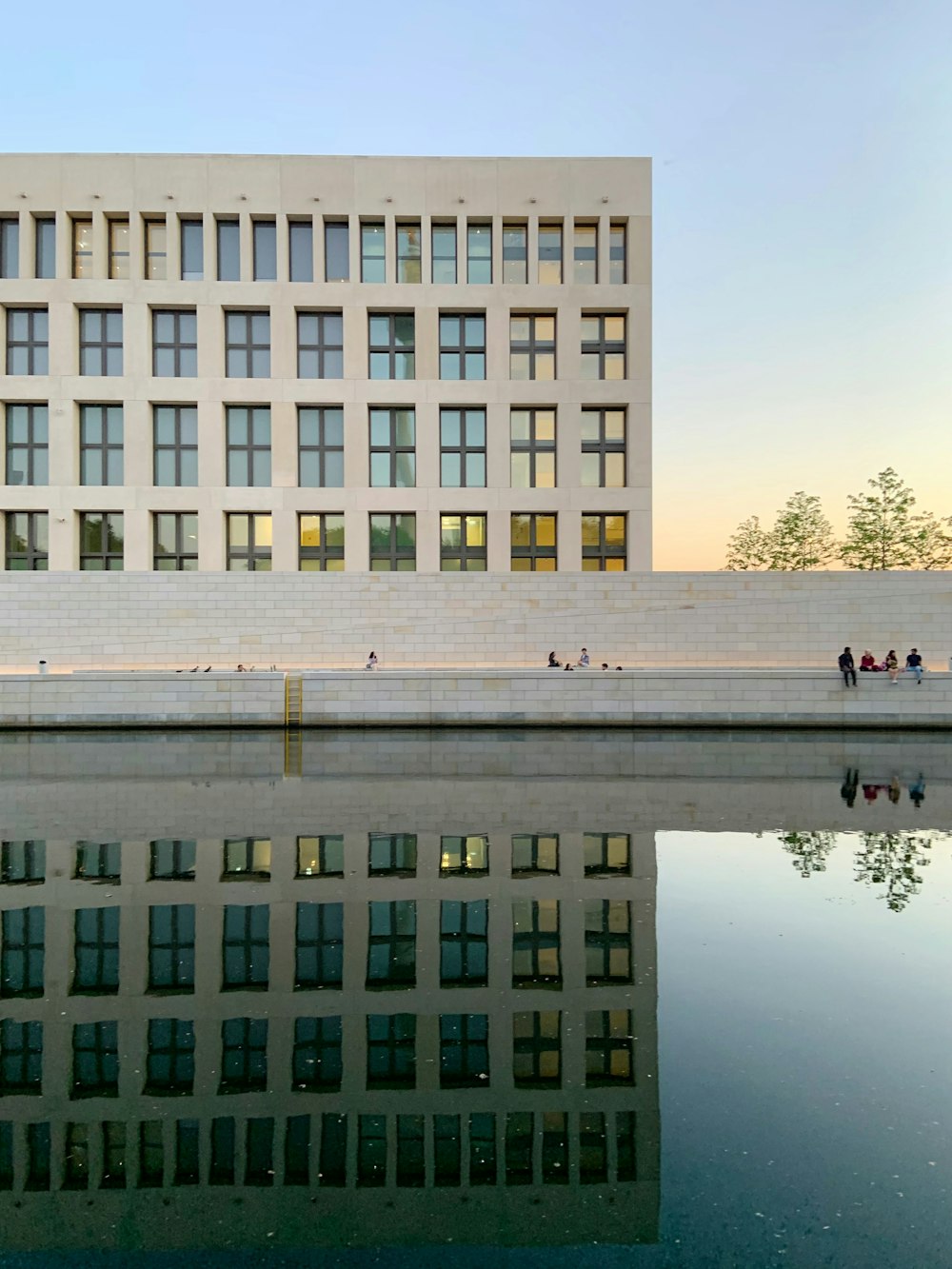 white concrete building near body of water during daytime