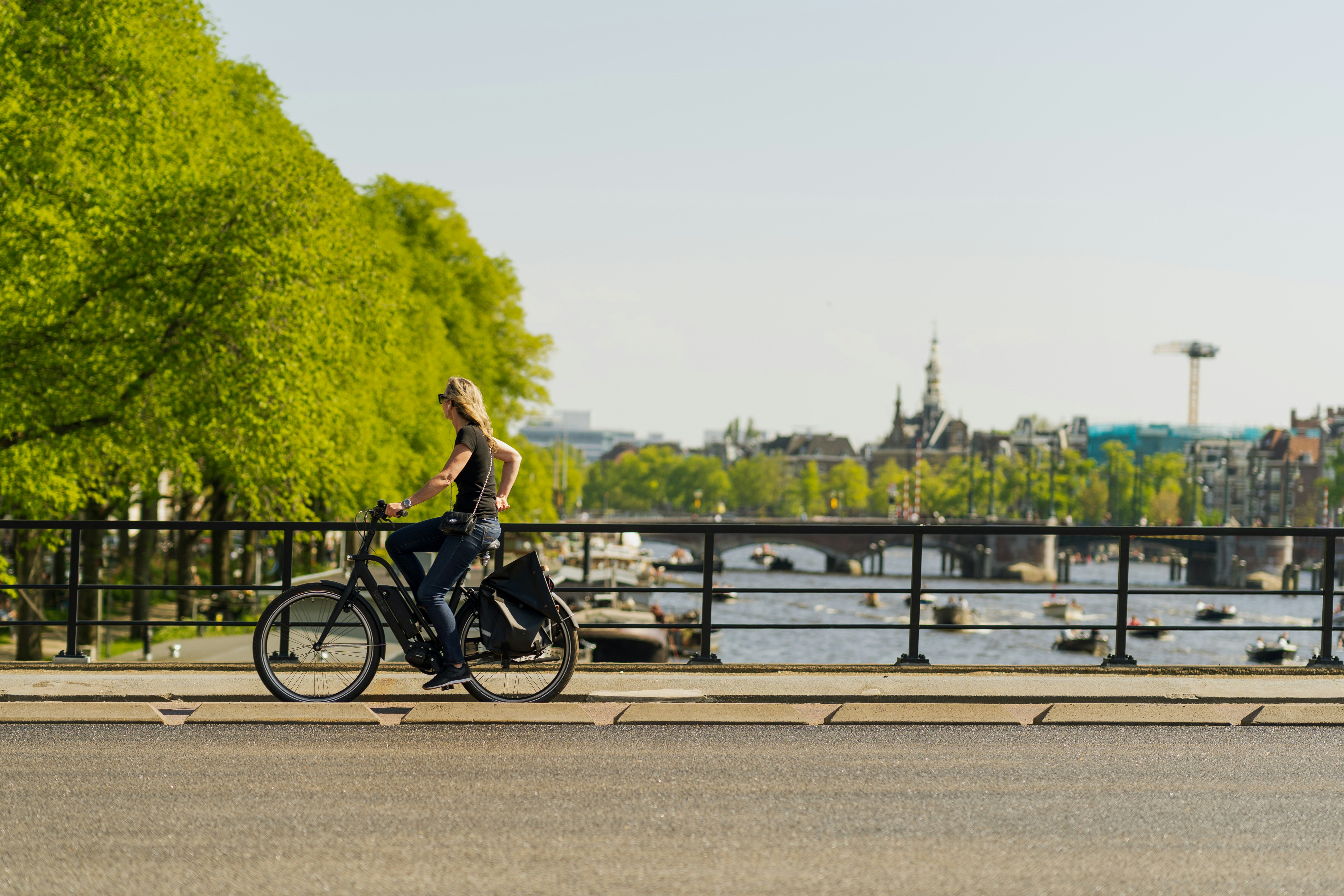 man in black shirt riding bicycle on road during daytime