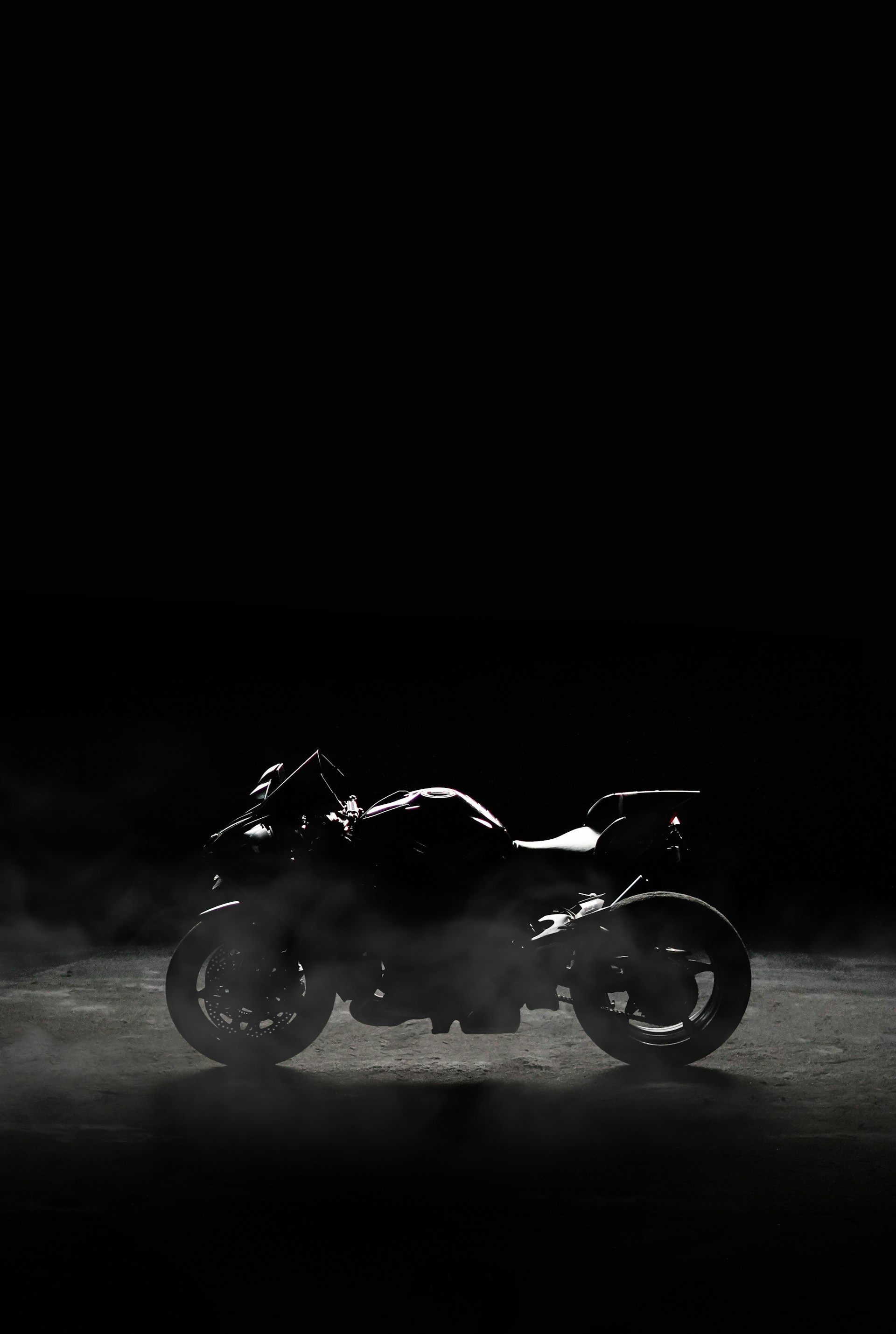 a black and white photo of a motorcycle in the dark
