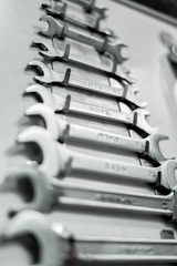 a bunch of wrenches are lined up on a table