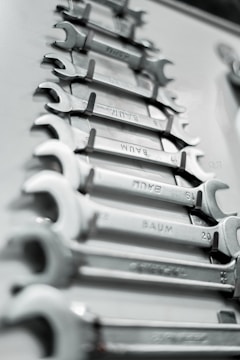 a bunch of wrenches are lined up on a table