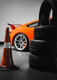 a car parked next to a pile of tires