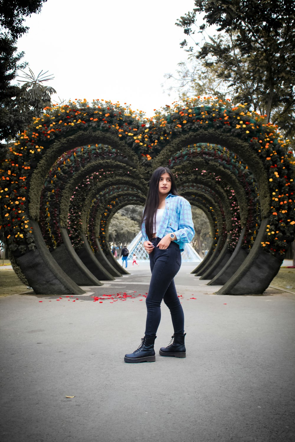 a woman standing in front of an orange sculpture