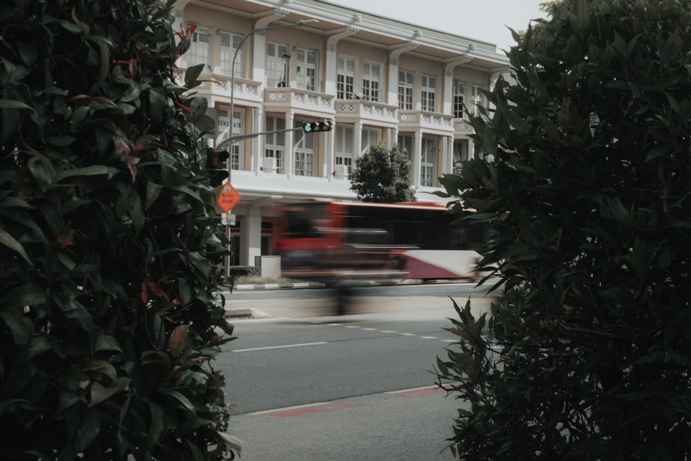 red car on road near building during daytime