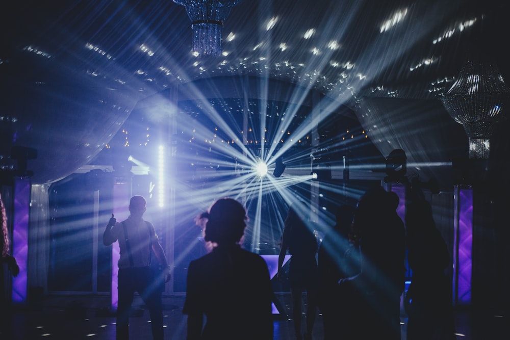 a group of people standing in front of a stage