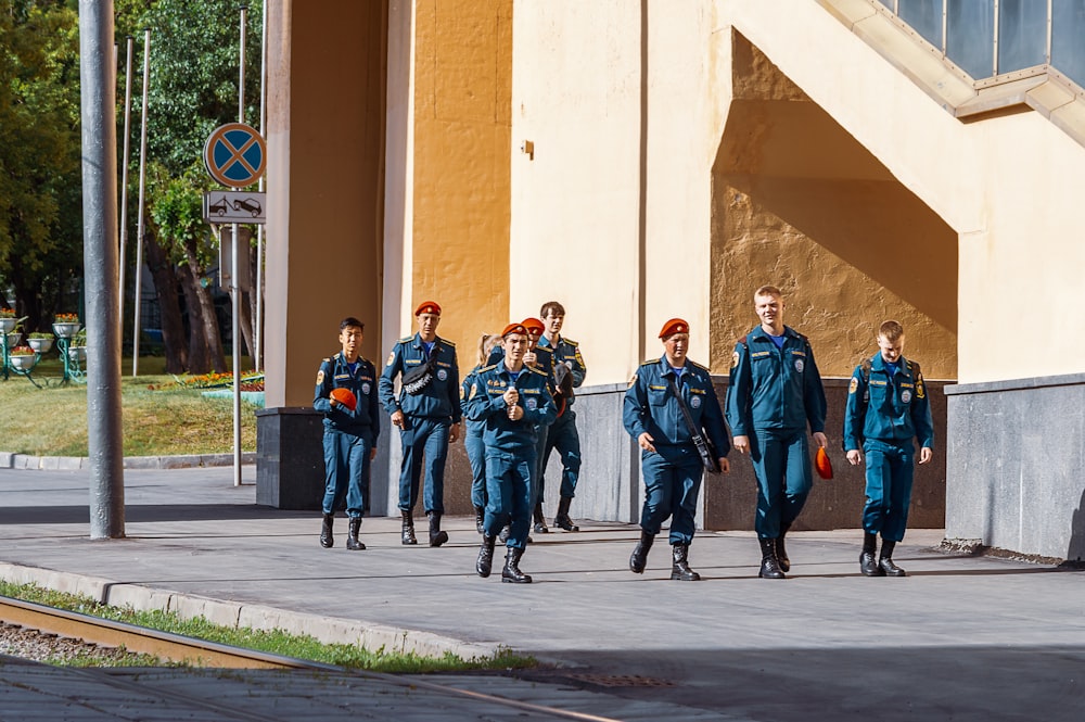 a group of uniformed men walking down a street
