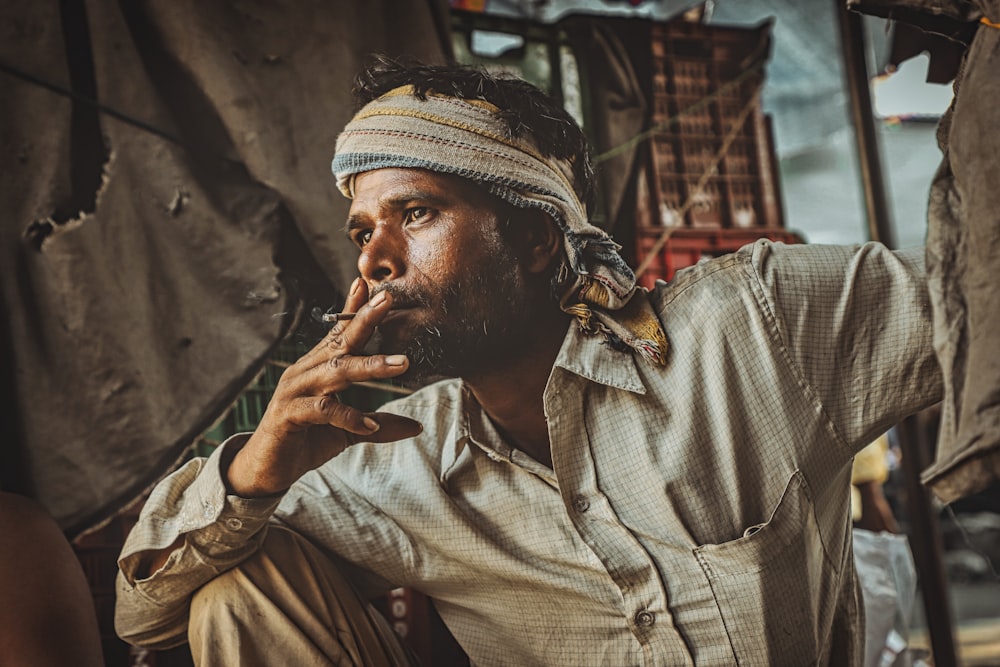 a man with a turban smoking a cigarette