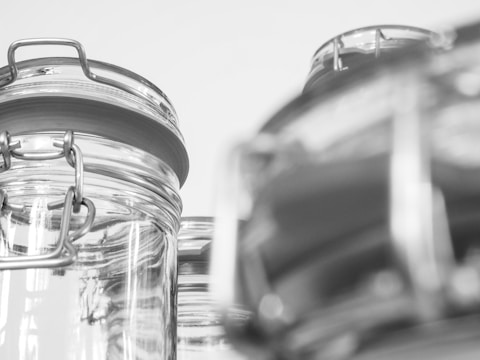 Close-up of bubbling fermentation jars with diverse microbes visible.