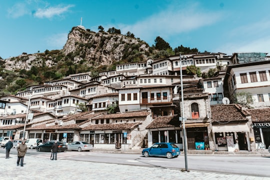 blue car parked near brown concrete building during daytime in Berat Albania