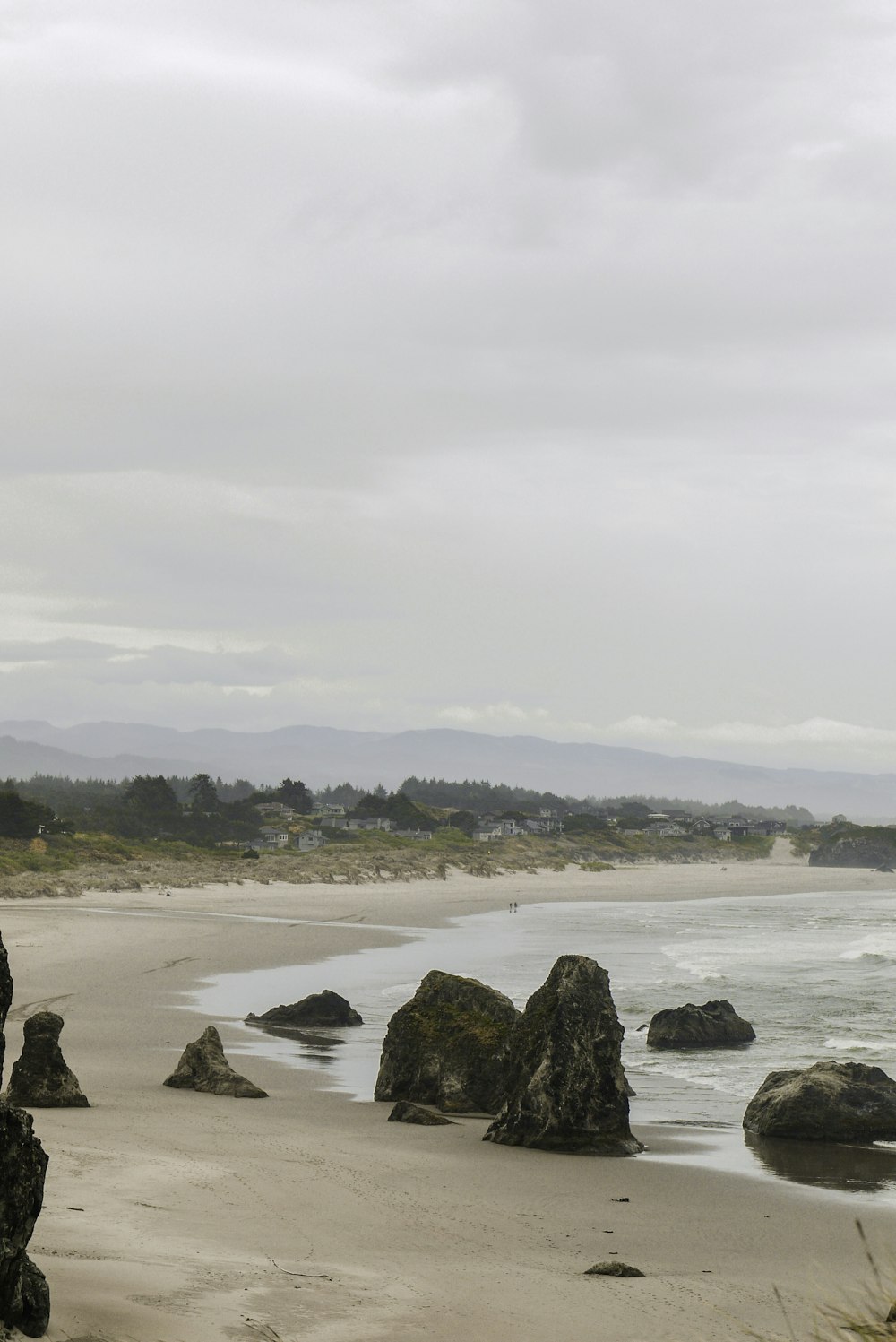 black rock formation on sea shore during daytime