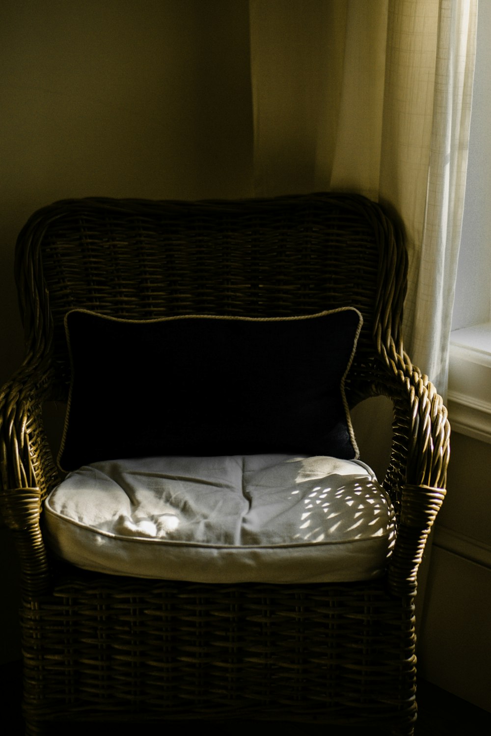 brown wooden framed white padded armchair