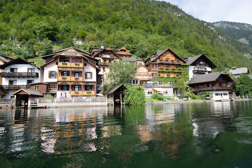 a row of houses on the shore of a lake