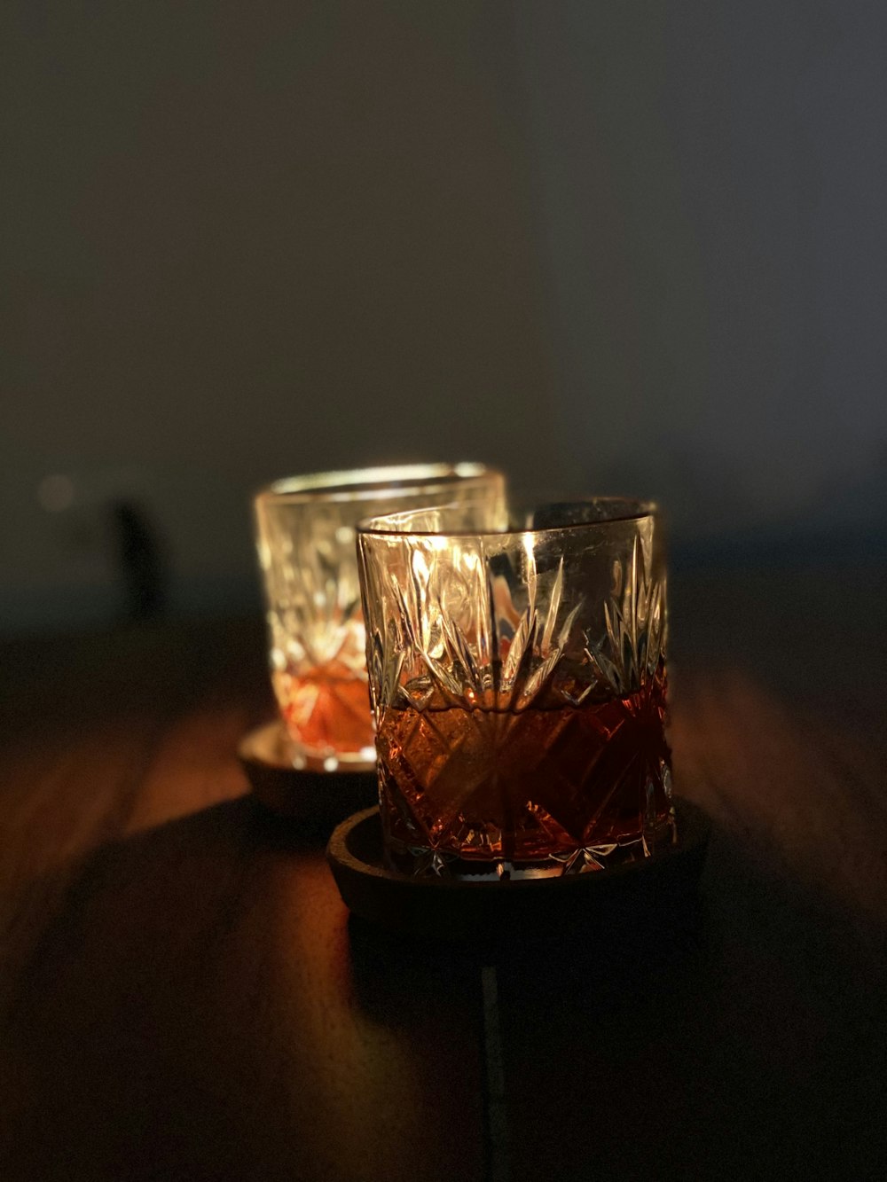 a couple of glasses sitting on top of a wooden table