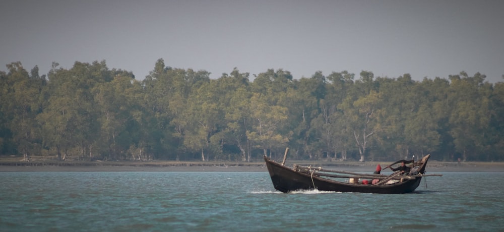 a small boat with people in it on the water