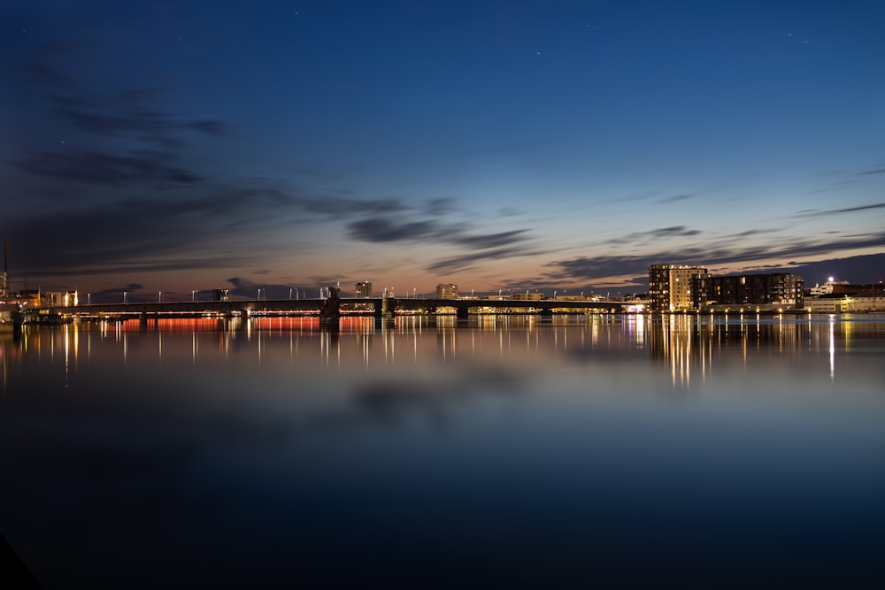 a view of a bridge over a body of water at night