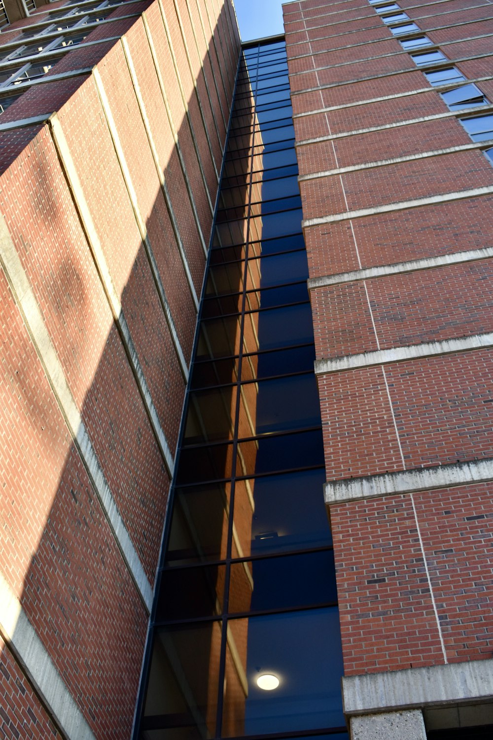 a tall brick building with a clock on the side of it