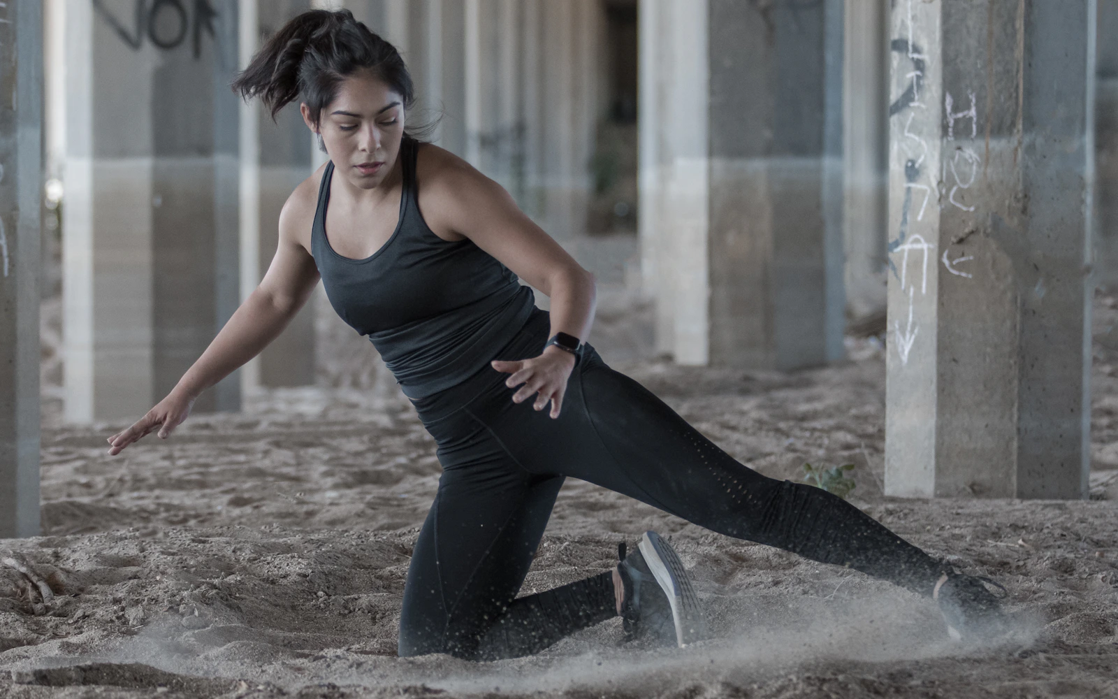 Woman wearing a black activewear set during a calm floor-based movement session