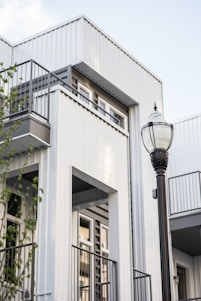 a street light in front of a white building
