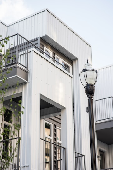 a street light in front of a white building