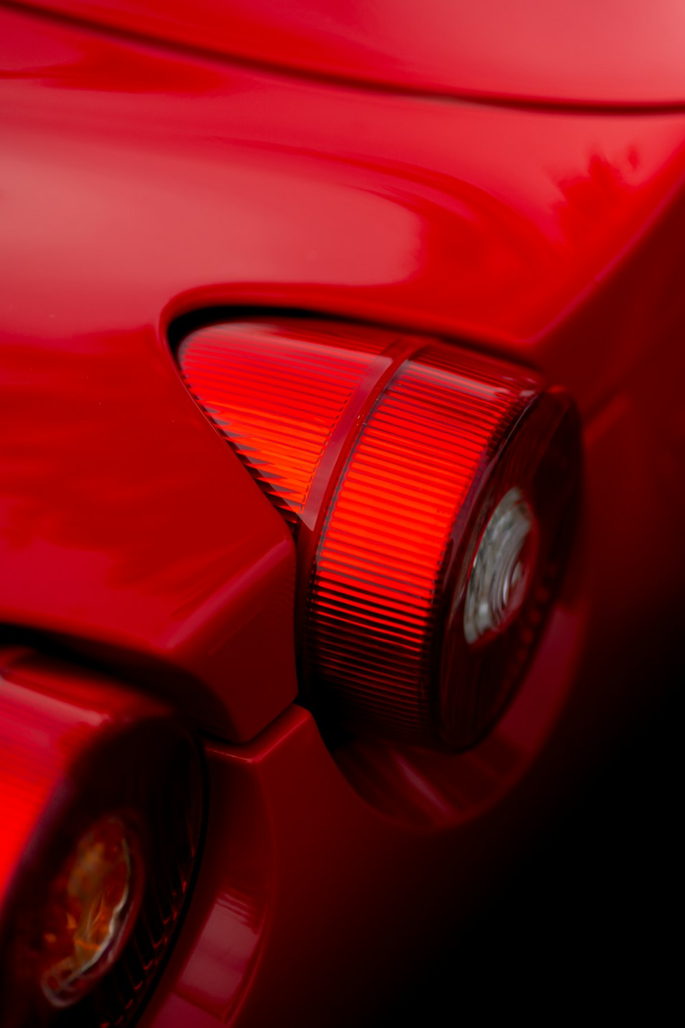 a close up of the tail light of a red car