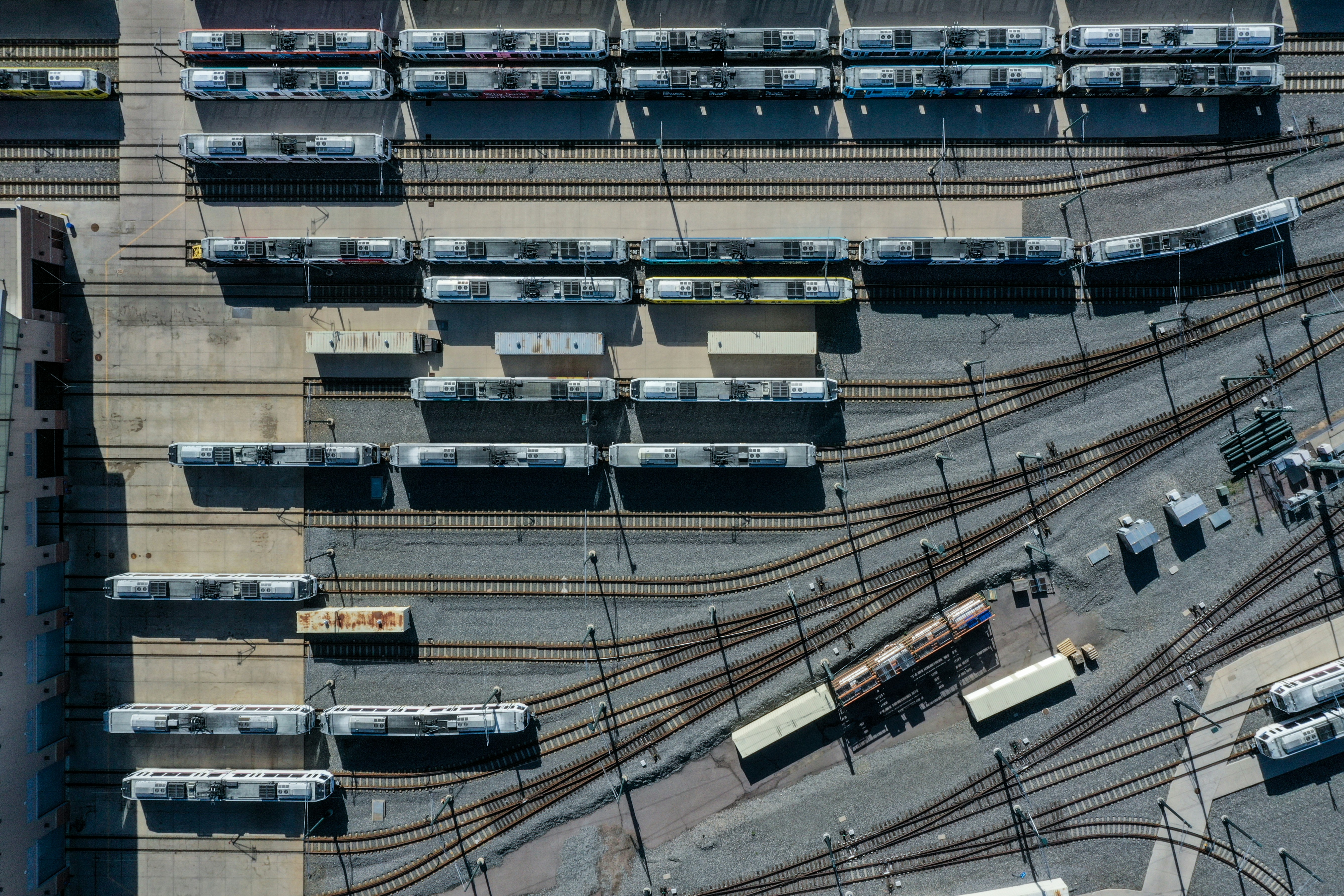 a train yard with many trains on the tracks, 