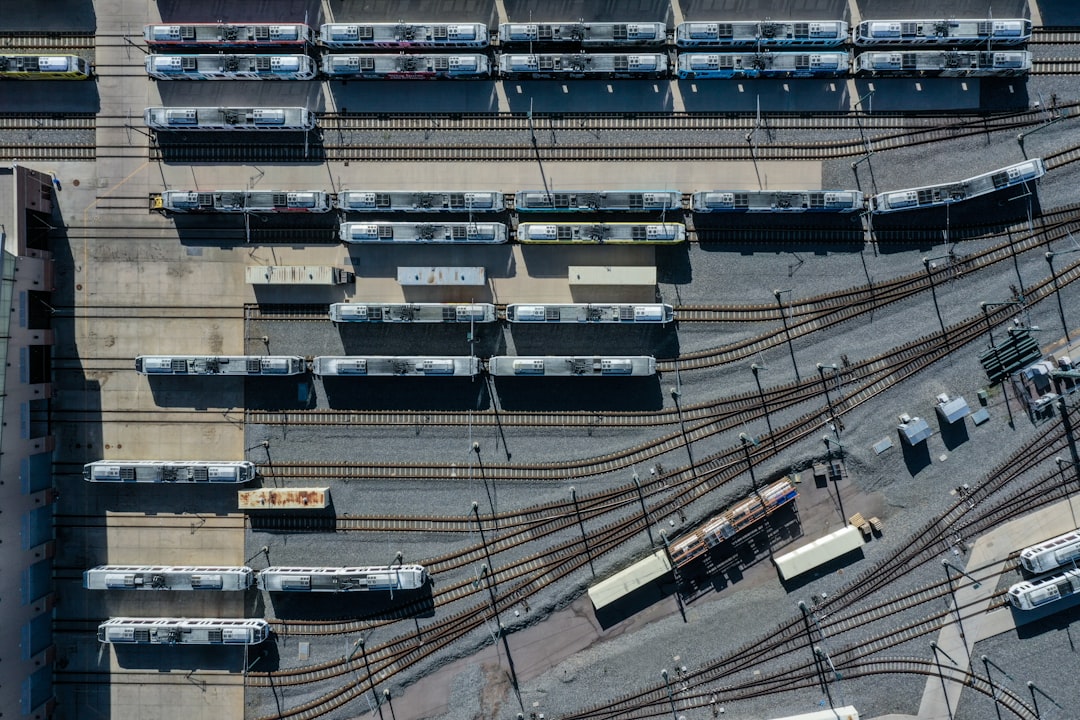 a train yard with many trains on the tracks,