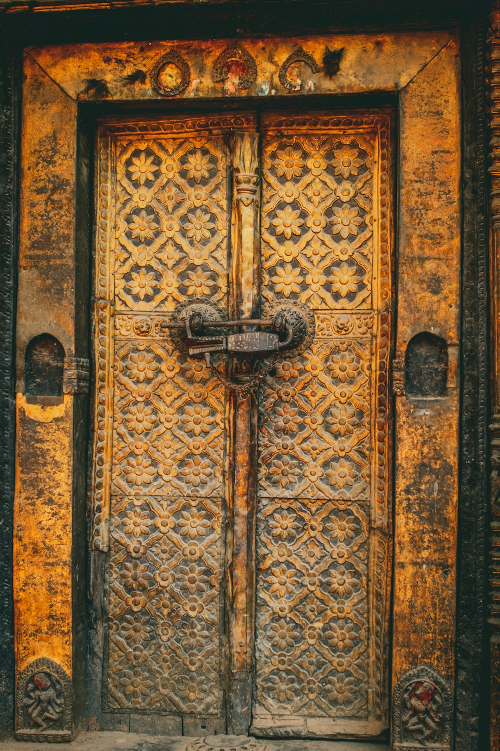 brown wooden door with black steel door lever