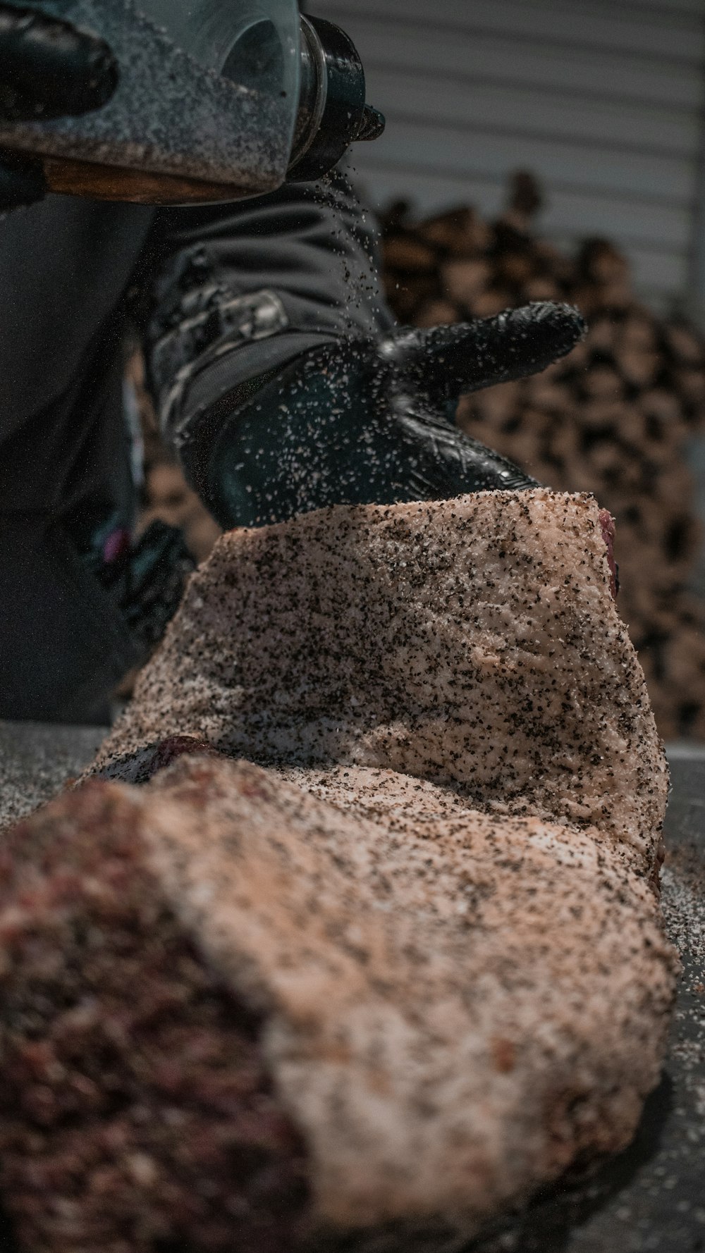 person in black pants and black shoes standing on brown rock