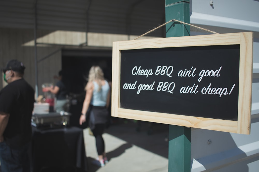 brown wooden framed black and white quote board