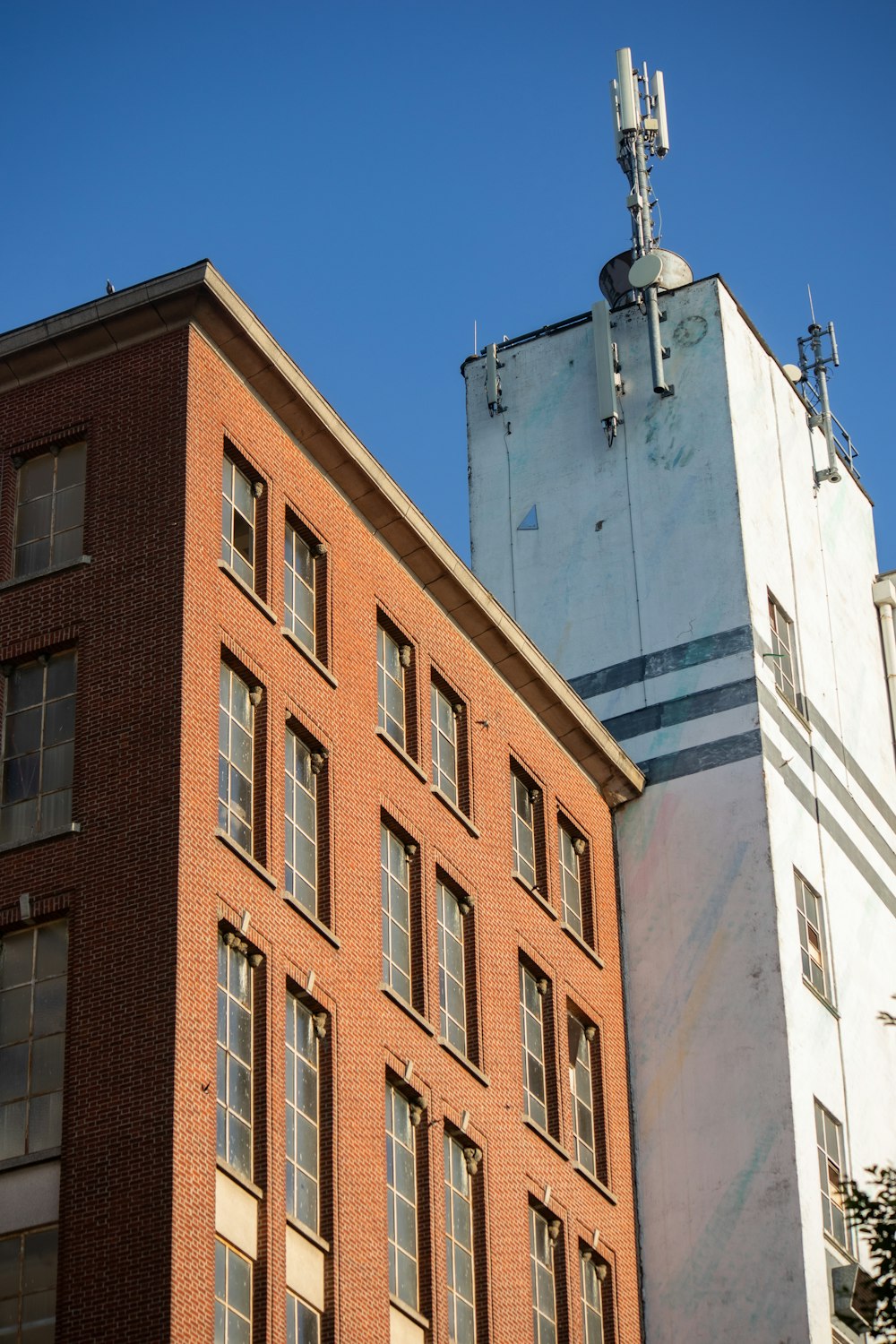 a tall brick building next to a tall brick building