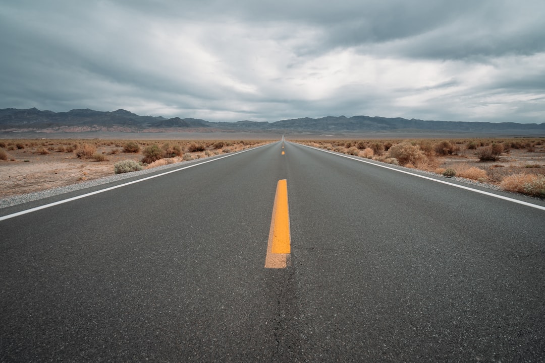 black asphalt road under cloudy sky during daytime