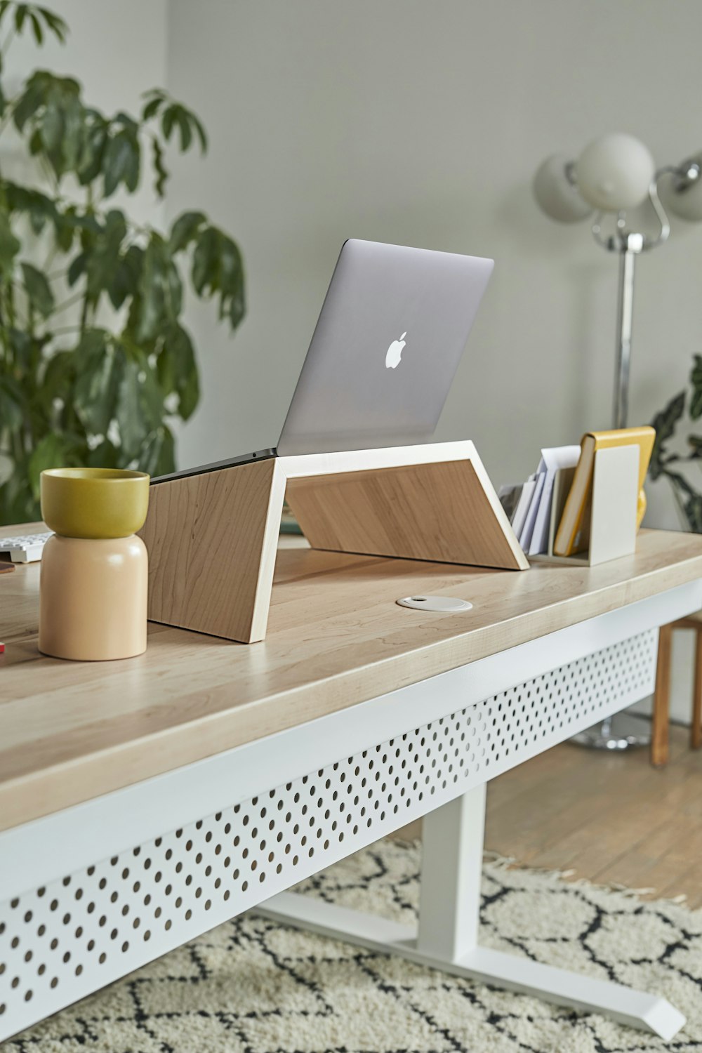 a laptop computer sitting on top of a wooden desk