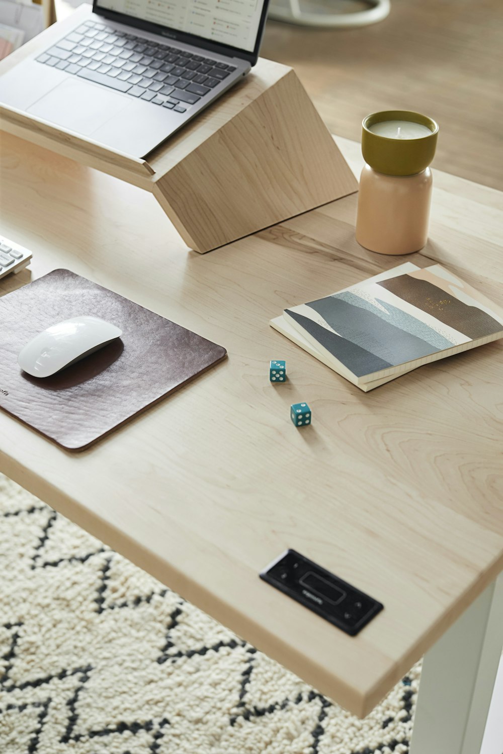 a desk with a laptop and a mouse on it