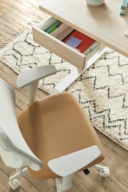 a desk with a chair and a drawer on top of it