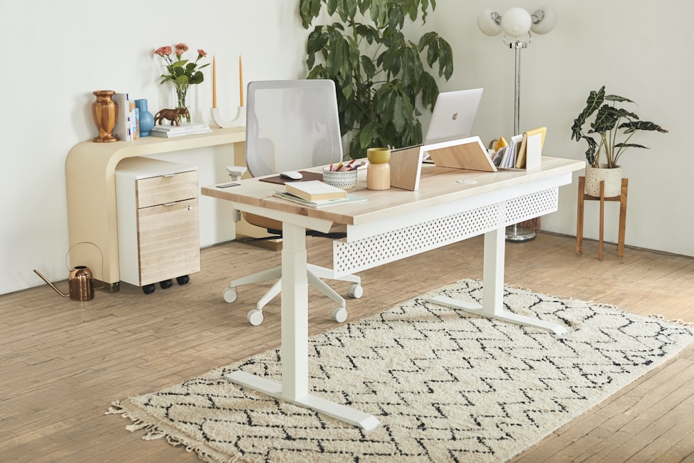 a white desk with a laptop on top of it